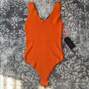 Black label orange knit body suit NWT